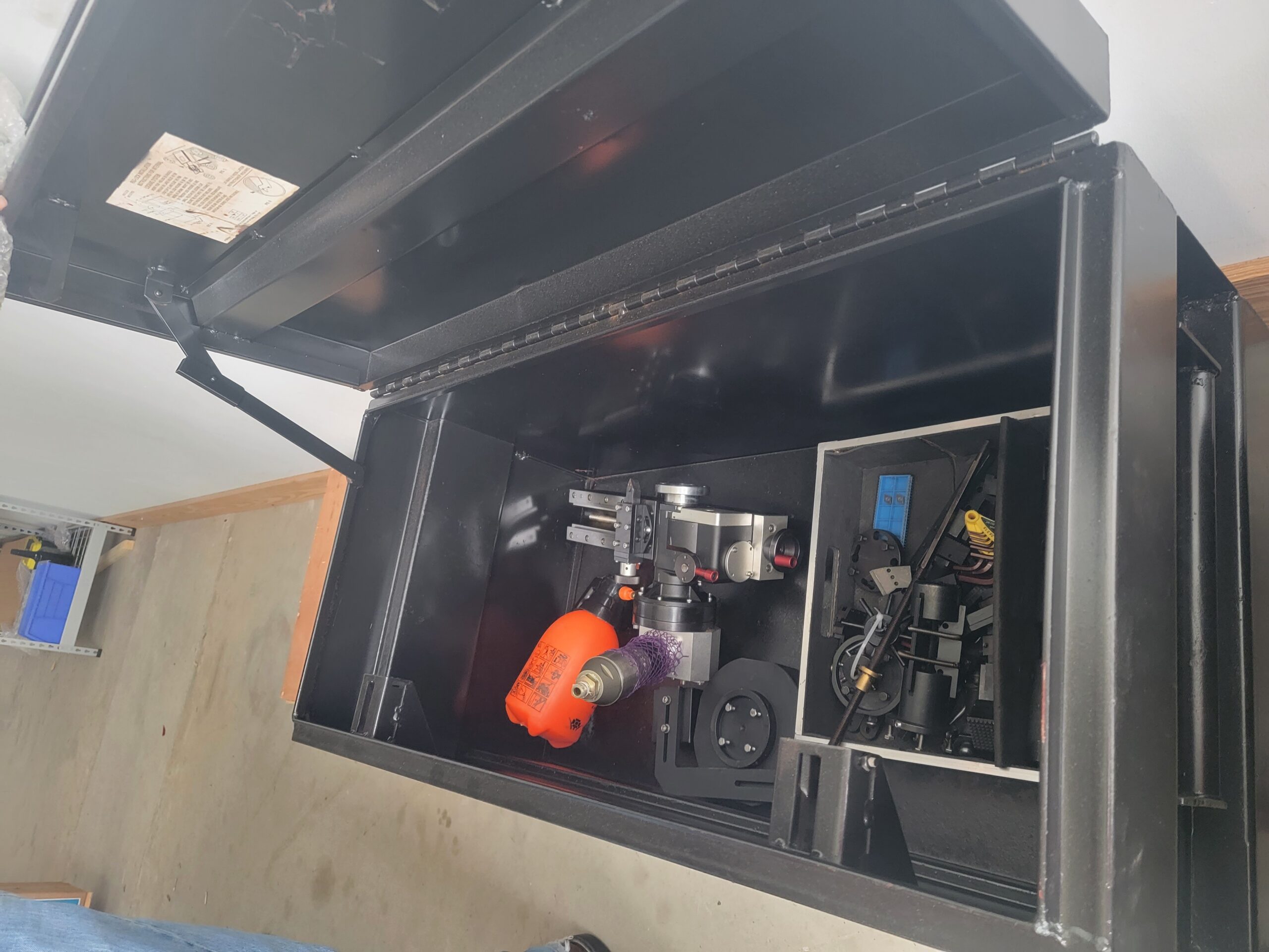 Close-up of a split-frame clamshell pipe cutter secured in a steel transport case—inventory-ready and prepped for shipment, showcasing rugged industrial packaging and tool integrity.