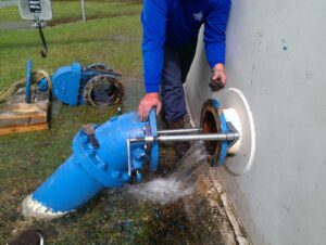 Field worker using the Valve Removal Tool to remove a valve.